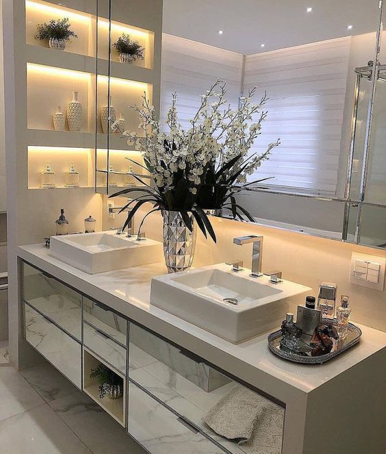 Atmosphère élégante. Les détails floraux sous le comptoir créent une salle de bain luxueuse. 
