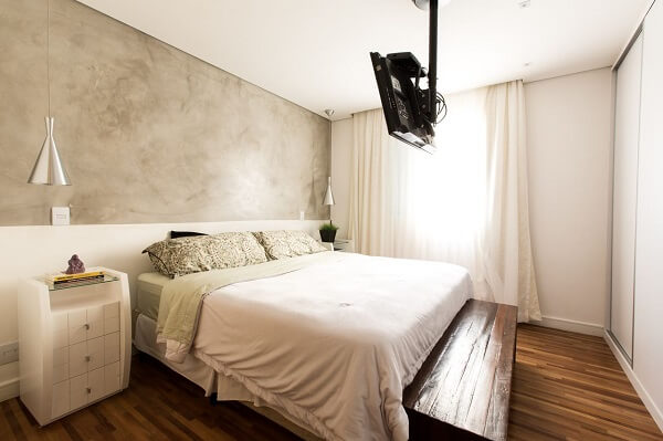 Chambre moderne avec murs en ciment brûlé et mobilier blanc.